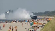 Russian Navy Hovercraft Lands On Busy Beach 