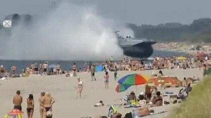 Russian Navy Hovercraft Lands On Busy Beach 