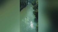 LiveLeak - People kayak on single sticks of bamboo down a river in Chinas Wangmo