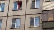 Kobieta ratuję kota który utknął w oknie