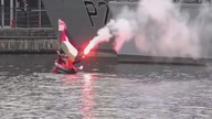 LiveLeak - Activists in a CANOE breach DSEi Arms Fair Security waving Palestinian flag